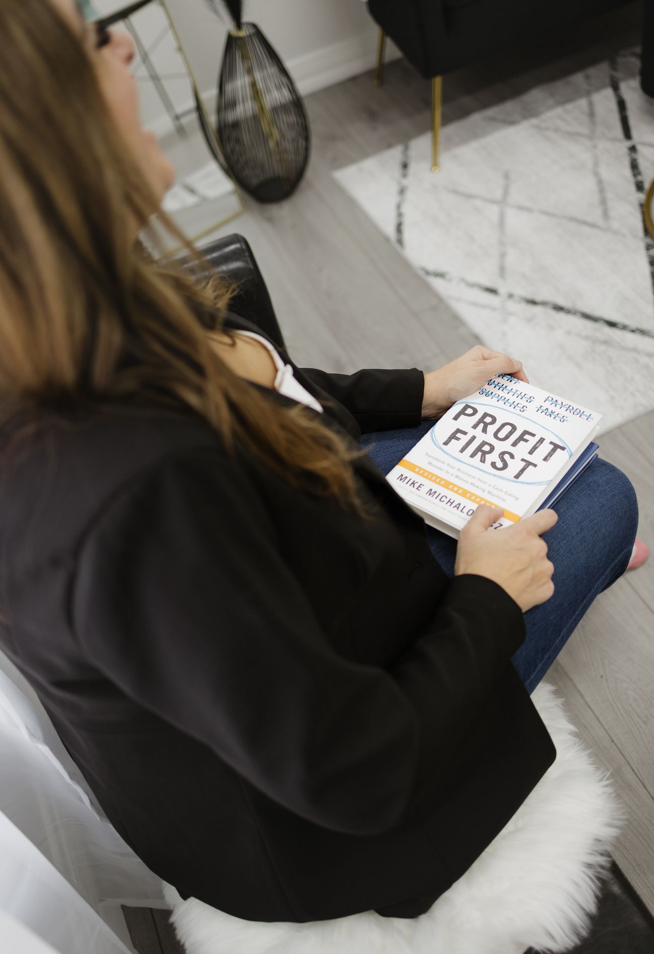 Jennifer Hume holding a copy of the book Profit First